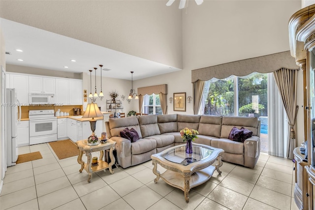11919 NW 47th St, Coral Springs, FL 33076 - living room with healthy amount of natural light, light tile patterned floors, recessed lighting, ceiling fan, and a high ceiling