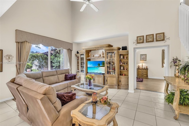 11919 NW 47th St, Coral Springs, FL 33076 - living area featuring a towering ceiling, light tile patterned flooring, ceiling fan, and baseboards