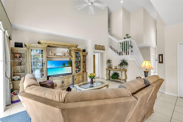11919 NW 47th St, Coral Springs, FL 33076 - living room featuring a towering ceiling, light tile patterned flooring, a ceiling fan, stairs, and baseboards