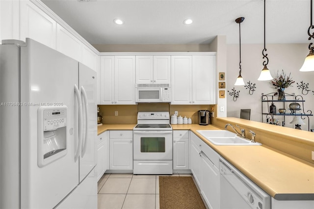 11919 NW 47th St, Coral Springs, FL 33076 - kitchen with white appliances, a sink, light tile patterned flooring, white cabinets, and a peninsula