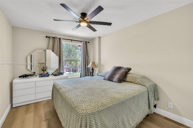 11919 NW 47th St, Coral Springs, FL 33076 - bedroom featuring baseboards, light wood-style flooring, and a ceiling fan