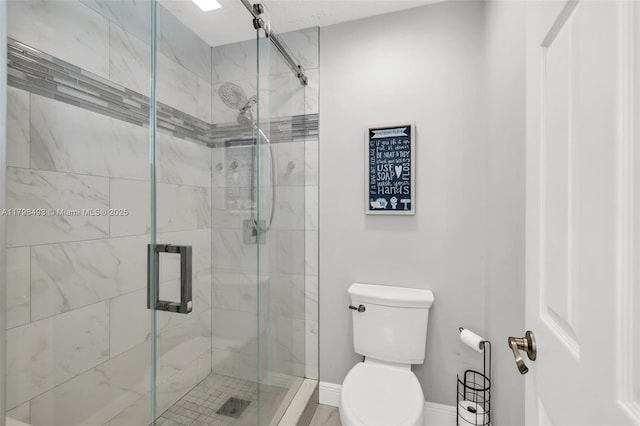 11919 NW 47th St, Coral Springs, FL 33076 - bathroom featuring toilet, a shower stall, and baseboards