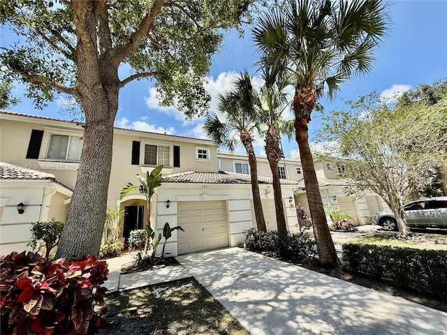 4855 Palmbrooke Cir, West Palm Beach, FL 33417 - multi unit property with stucco siding, driveway, an attached garage, and a tiled roof
