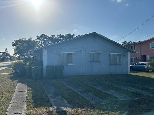 1207 NE 1st Ave, Homestead, FL 33030 - view of home's exterior featuring stucco siding and a lawn