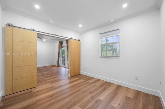 1400 Salzedo St Unit 208, Coral Gables, FL 33134 - unfurnished bedroom featuring light wood finished floors, multiple windows, ornamental molding, recessed lighting, and a barn door