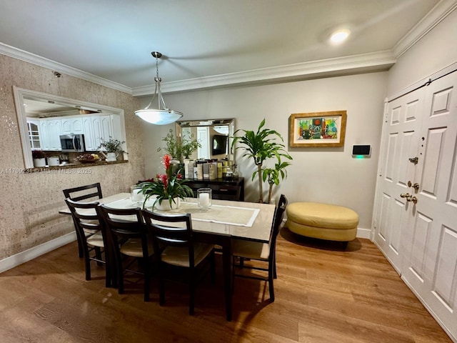 1400 Salzedo St Unit 208, Coral Gables, FL 33134 - dining space featuring wood finished floors and crown molding