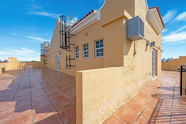 1400 Salzedo St Unit 208, Coral Gables, FL 33134 - view of side of home with stucco siding, a tile roof, and a patio