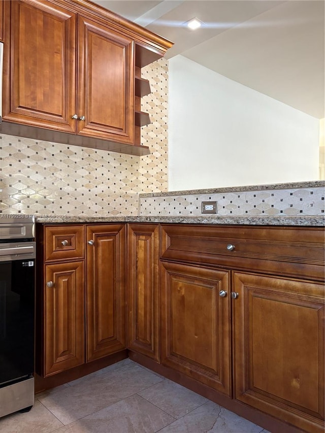 2650 NW 67th Ter, Margate, FL 33063 - kitchen featuring brown cabinets, open shelves, light tile patterned floors, and light stone countertops
