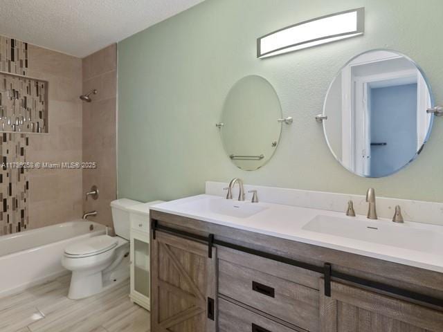 2650 NW 67th Ter, Margate, FL 33063 - bathroom with double vanity, bathtub / shower combination, a textured ceiling, and wood finished floors