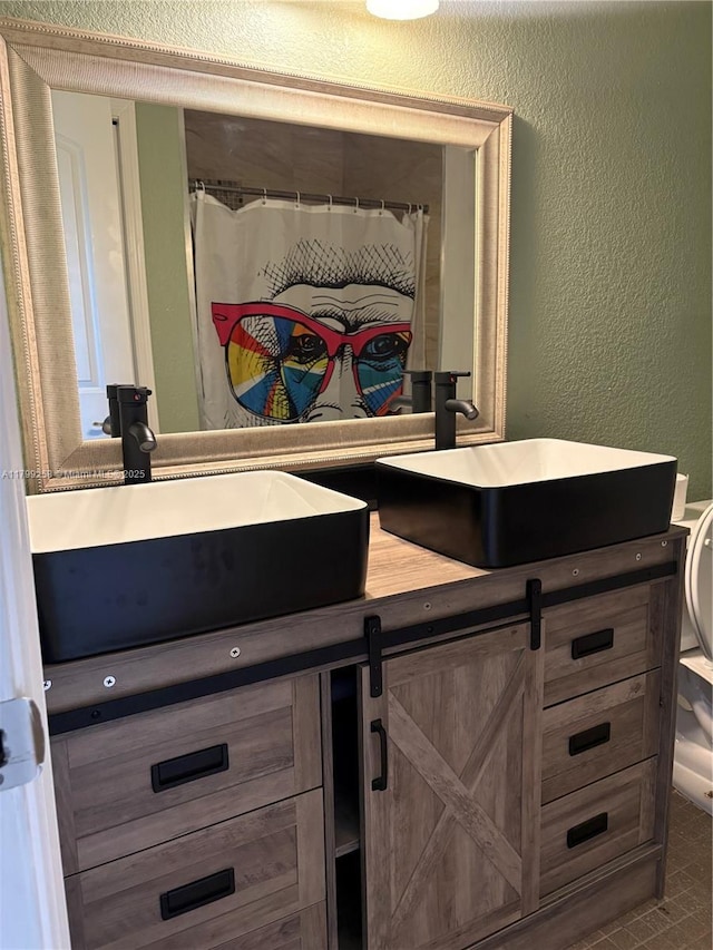 2650 NW 67th Ter, Margate, FL 33063 - bathroom with double vanity and a textured wall