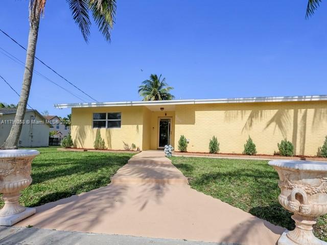 2650 NW 67th Ter, Margate, FL 33063 - view of front facade with stucco siding and a front lawn