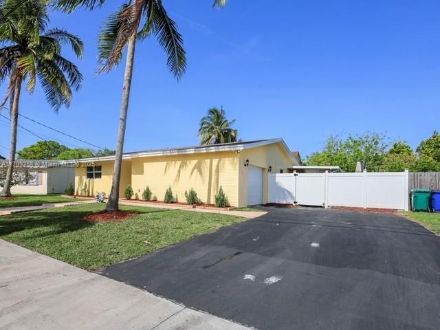2650 NW 67th Ter, Margate, FL 33063 - view of front facade with asphalt driveway, an attached garage, and stucco siding