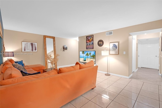 living area with light tile patterned floors and baseboards