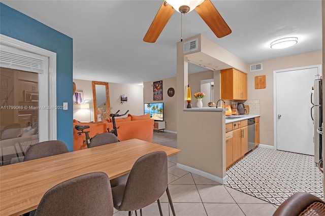 dining room featuring ceiling fan, light tile patterned floors, and baseboards