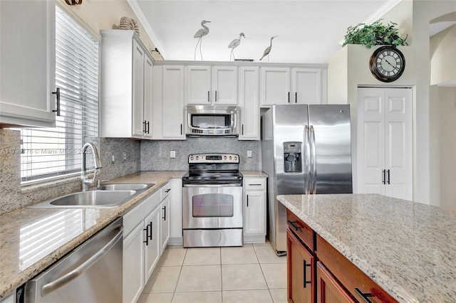 14284 NW 18th Mnr, Pembroke Pines, FL 33028 - kitchen with stainless steel appliances, a sink, light tile patterned floors, tasteful backsplash, and light stone countertops