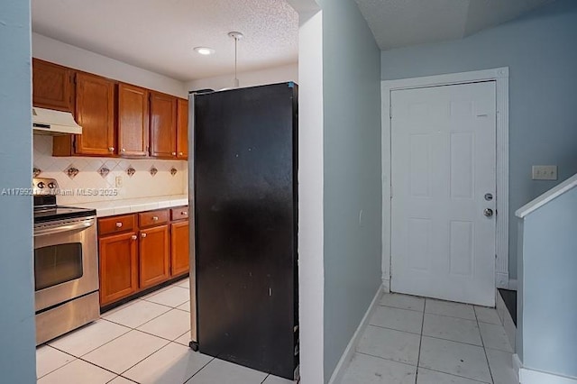 5154 Breckenridge Pl Unit 47, West Palm Beach, FL 33417 - kitchen with electric stove, freestanding refrigerator, under cabinet range hood, light tile patterned flooring, and tasteful backsplash