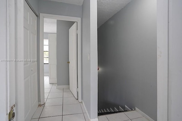 5154 Breckenridge Pl Unit 47, West Palm Beach, FL 33417 - corridor with light tile patterned flooring, baseboards, and a textured ceiling