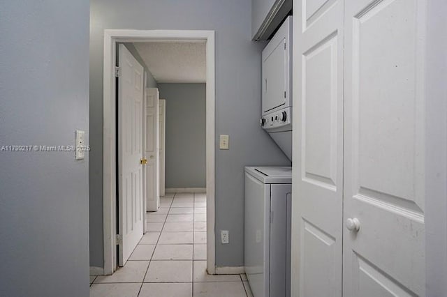 5154 Breckenridge Pl Unit 47, West Palm Beach, FL 33417 - washroom with stacked washer / dryer, light tile patterned floors, baseboards, and a textured ceiling