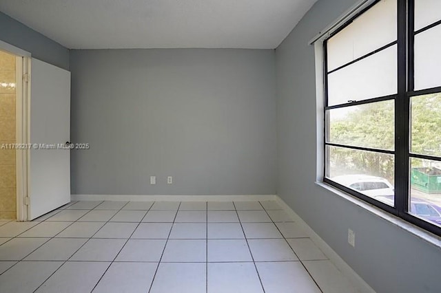 5154 Breckenridge Pl Unit 47, West Palm Beach, FL 33417 - spare room with plenty of natural light, light tile patterned flooring, and baseboards