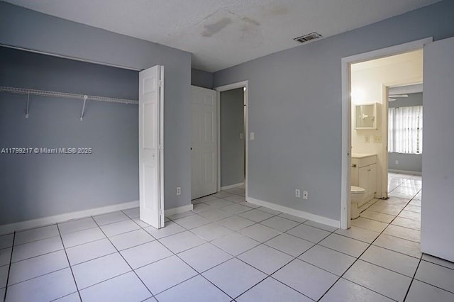5154 Breckenridge Pl Unit 47, West Palm Beach, FL 33417 - unfurnished bedroom featuring baseboards and light tile patterned floors