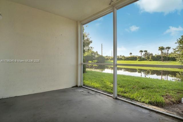 815 W Boynton Beach Blvd Unit 5-103, Boynton Beach, FL 33426 - unfurnished sunroom featuring a water view