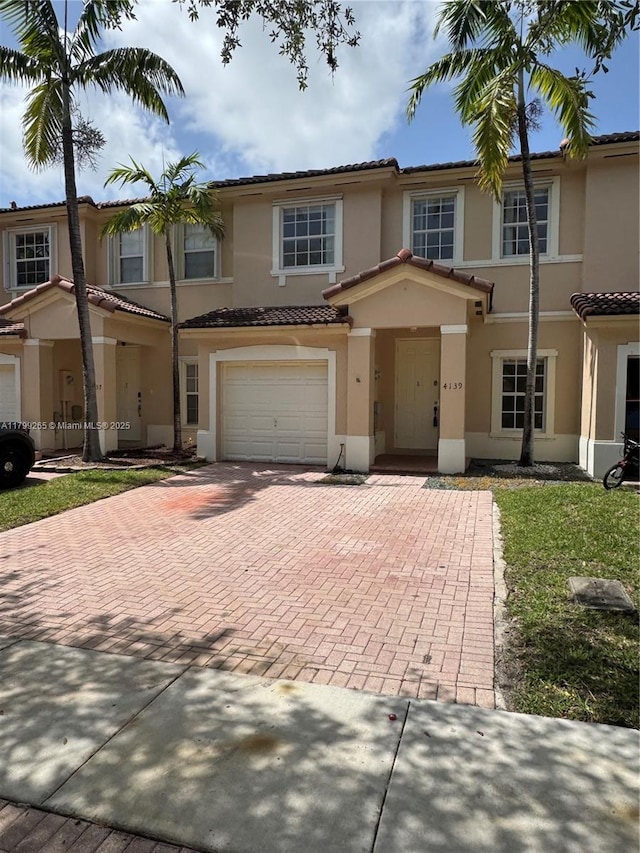 4139 NE 26th St, Homestead, FL 33033 - multi unit property featuring decorative driveway, stucco siding, a tiled roof, and an attached garage