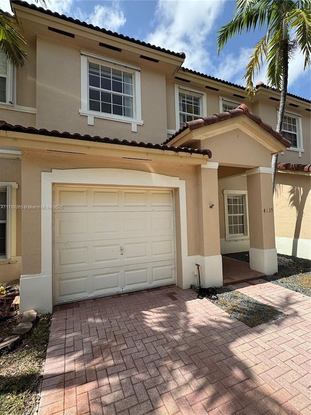4139 NE 26th St, Homestead, FL 33033 - multi unit property with an attached garage, stucco siding, a tiled roof, and decorative driveway