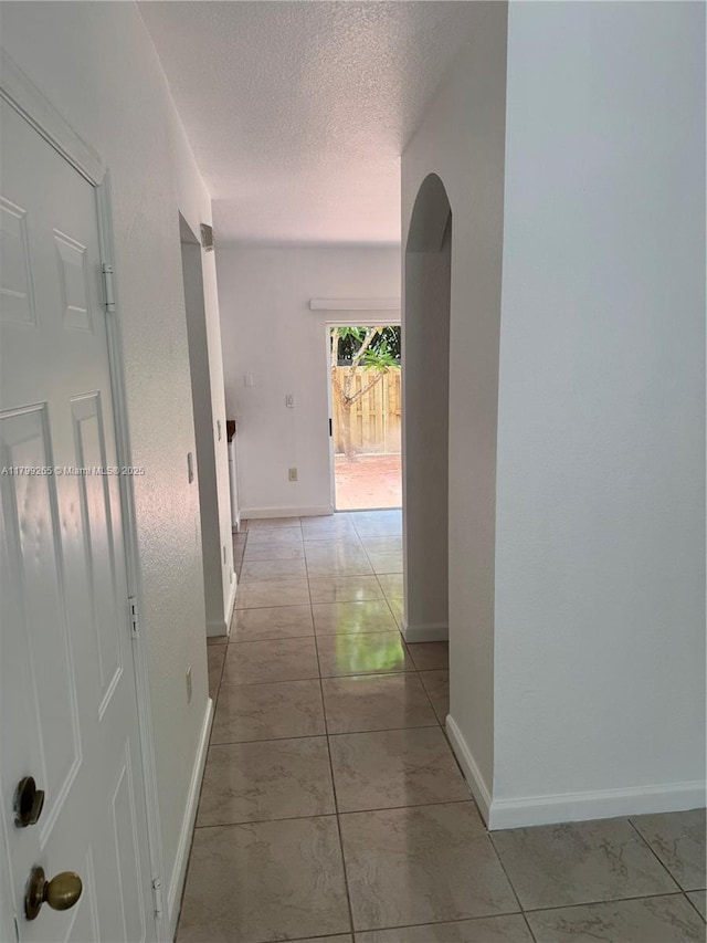 4139 NE 26th St, Homestead, FL 33033 - corridor featuring a textured ceiling and arched walkways