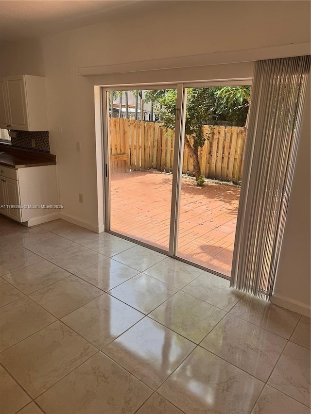 4139 NE 26th St, Homestead, FL 33033 - doorway featuring baseboards and light tile patterned floors