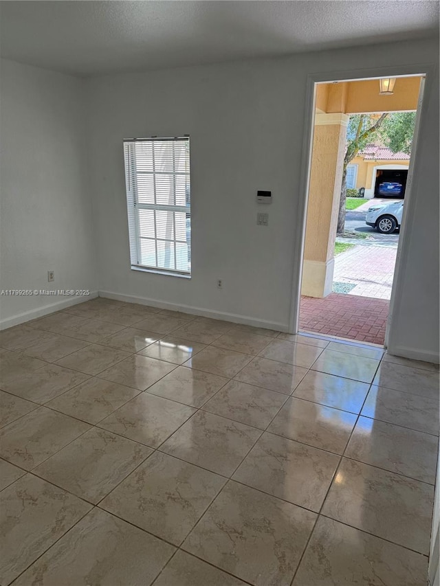 4139 NE 26th St, Homestead, FL 33033 - spare room featuring baseboards and a textured ceiling