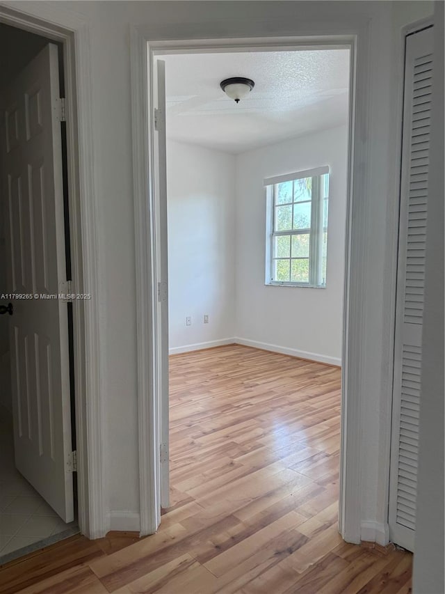 4139 NE 26th St, Homestead, FL 33033 - hallway featuring light wood-style flooring and baseboards