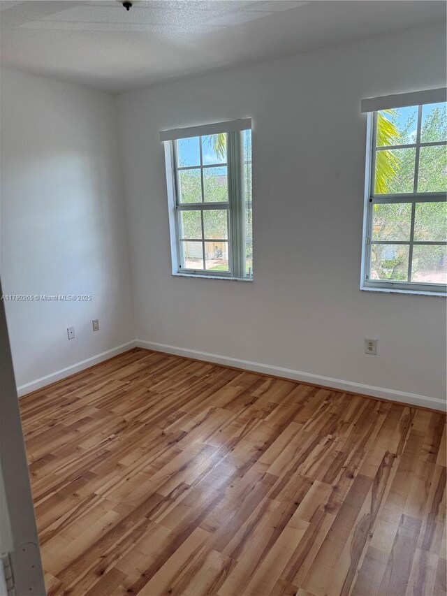4139 NE 26th St, Homestead, FL 33033 - empty room with light wood-style floors and baseboards