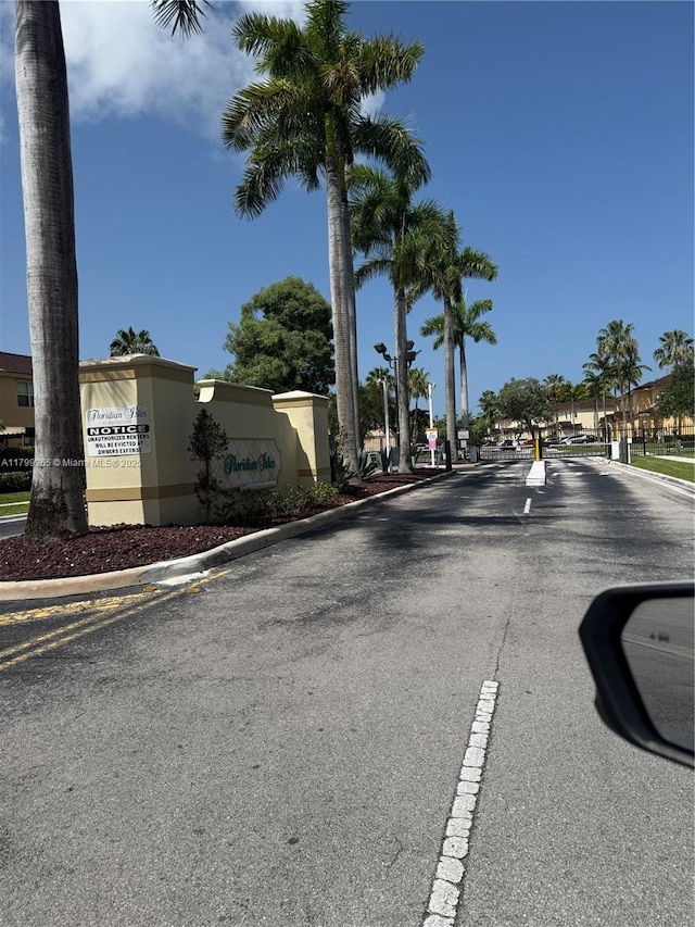 4139 NE 26th St, Homestead, FL 33033 - view of asphalt street featuring curbs and a gated entry
