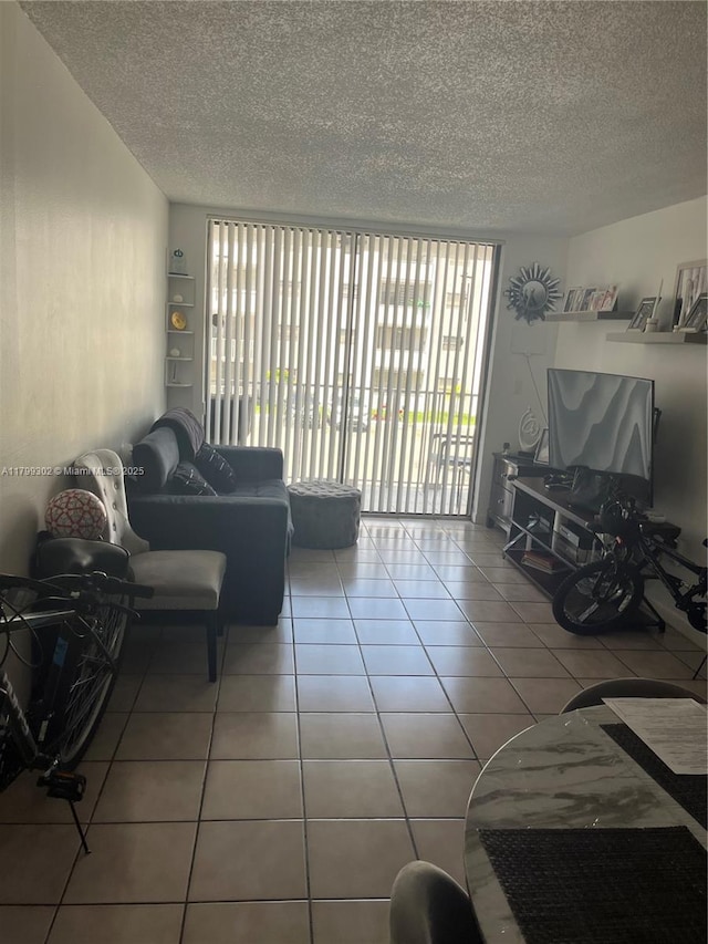 8145 NW 7th St Unit 211, Miami, FL 33126 - tiled living room with a textured ceiling and healthy amount of natural light