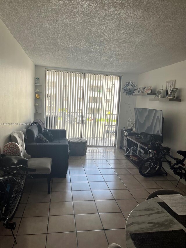 8145 NW 7th St Unit 211, Miami, FL 33126 - living area featuring a textured ceiling and tile patterned flooring