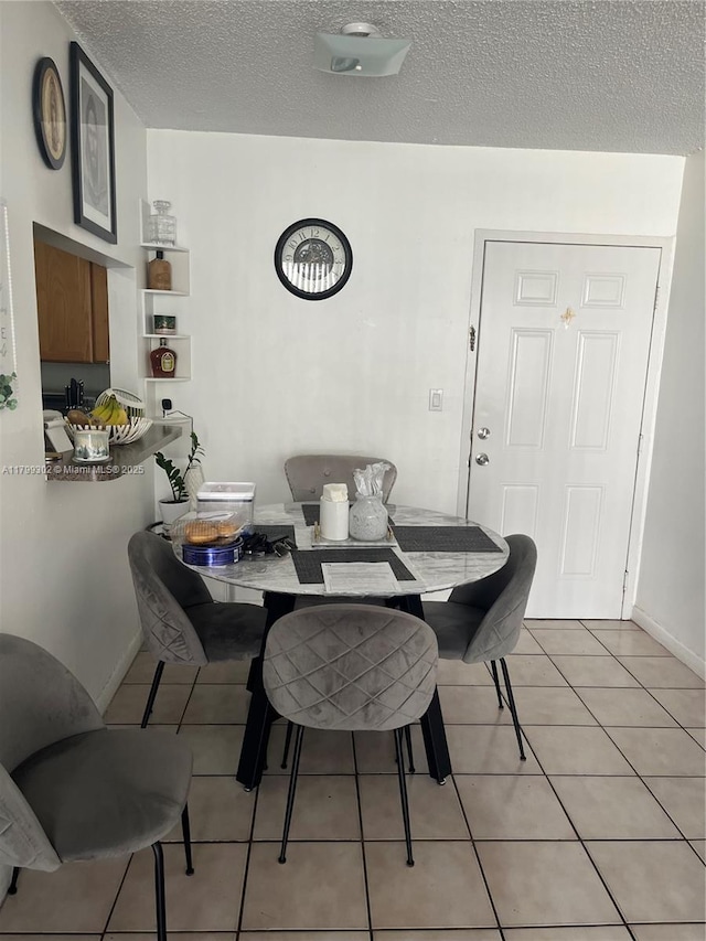 8145 NW 7th St Unit 211, Miami, FL 33126 - dining area with a textured ceiling and light tile patterned floors