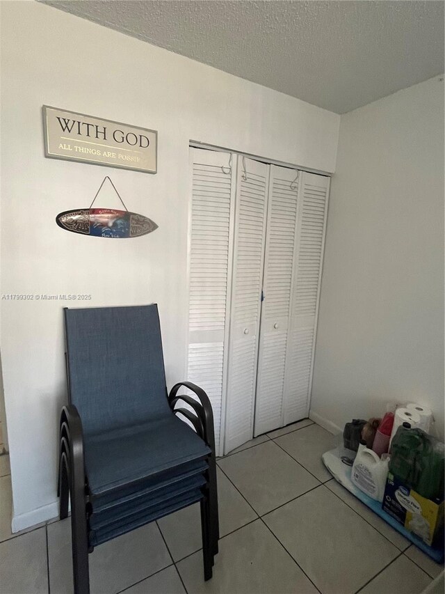 8145 NW 7th St Unit 211, Miami, FL 33126 - living area featuring tile patterned floors and a textured ceiling