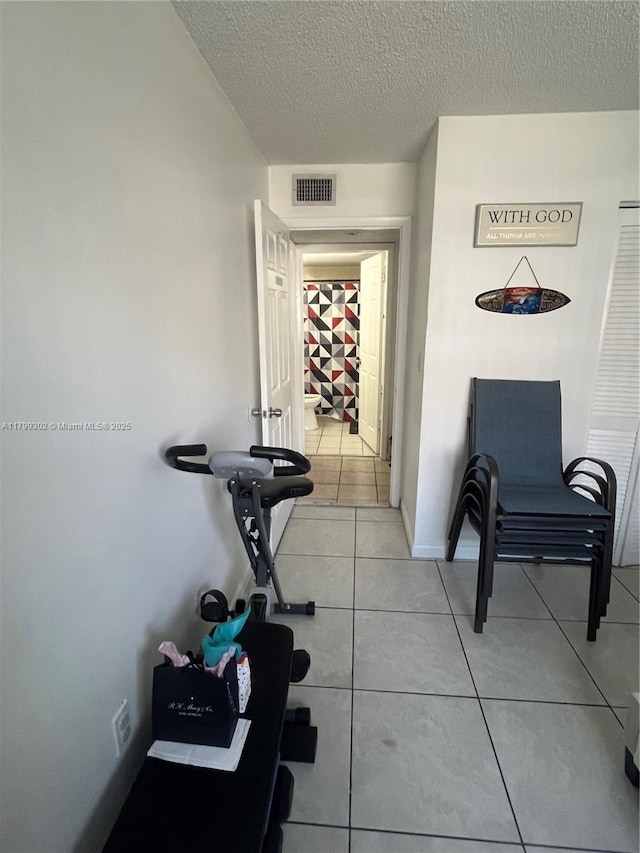 8145 NW 7th St Unit 211, Miami, FL 33126 - corridor featuring a textured ceiling and light tile patterned floors
