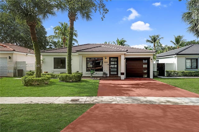 9054 NW 193rd Ter, Hialeah, FL 33018 - view of front of home featuring a tile roof, a garage, stucco siding, driveway, and a front yard