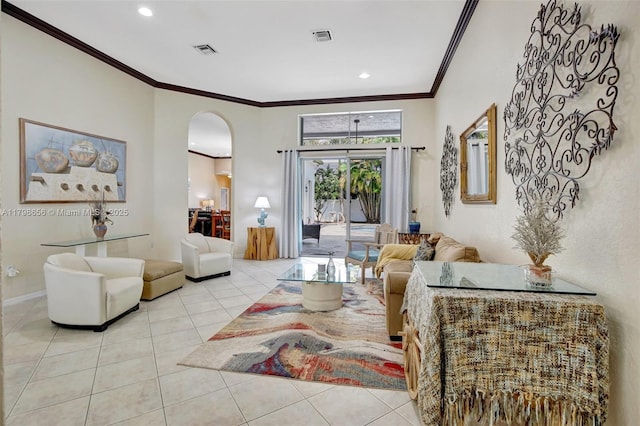 tiled living area with arched walkways, ornamental molding, recessed lighting, and baseboards