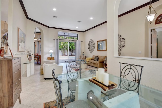 dining room featuring arched walkways, ornamental molding, light tile patterned flooring, and recessed lighting