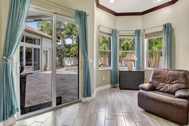 sitting room featuring crown molding, baseboards, and recessed lighting