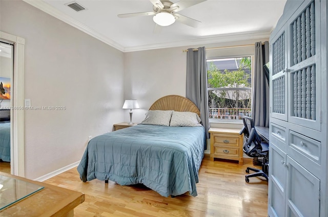 bedroom featuring a desk, crown molding, light wood-style floors, ceiling fan, and baseboards