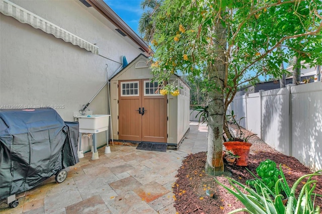 view of shed with a fenced backyard