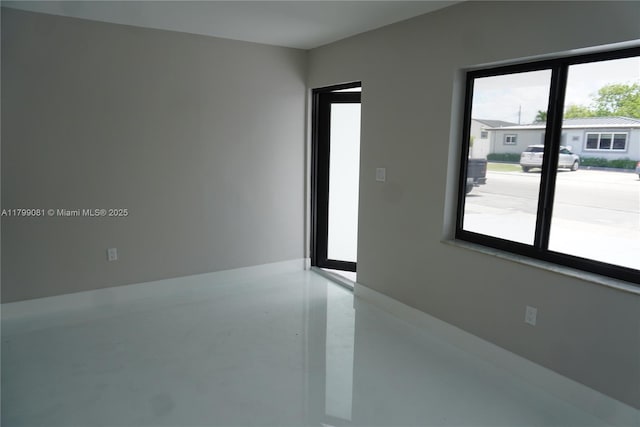 empty room with finished concrete flooring
