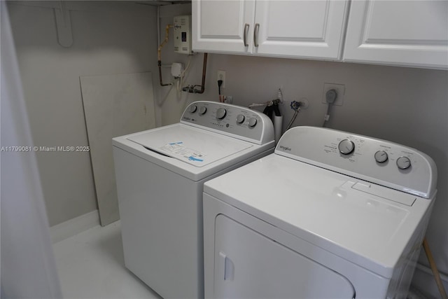 laundry room with separate washer and dryer and cabinet space