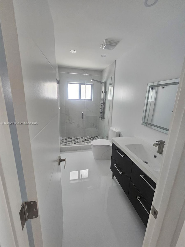full bathroom with a stall shower, toilet, and vanity