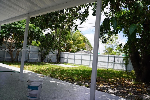 view of yard featuring fence and a patio area