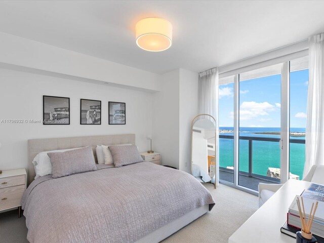 475 Brickell Ave Unit 5507, Miami, FL 33131 - carpeted bedroom with a water view, access to exterior, and expansive windows