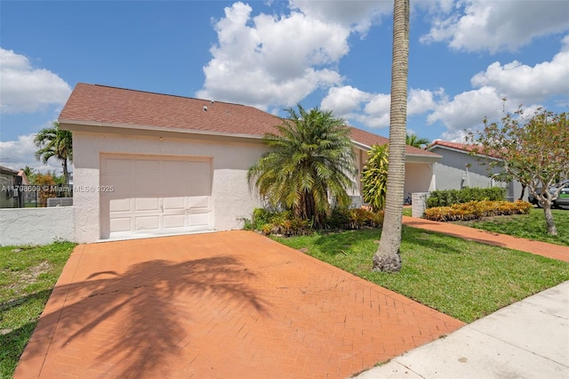 16791 Royal Poinciana Dr, Weston, FL 33326 - view of front facade featuring decorative driveway, stucco siding, a front lawn, and an attached garage
